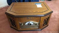 Full view of wooden octagonal Emerson CD digital audio player showing wood finish and speaker sections on each side.