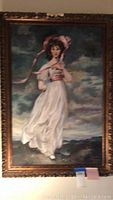Full view of framed acrylic painting showing a woman in white dress with pink bonnet outdoors under cloudy sky.
