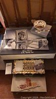 Overview of all three silver plated sets: boxed 3-piece vanity set, Amanda Smith bowl/spoon set on box, and silver plated toast rack with tray.