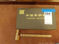 Green box labeled 'Chinese Bronze' with a ruler measuring approximately 12 inches showing scale.