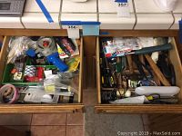 Two open wooden drawers filled with assorted hand tools and household hardware, seen from above.
