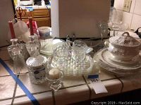Full view of the set on the countertop including glassware, ceramic tureen, and Corningware casserole dish