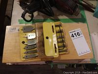 Overall photo showing both sets on a wooden surface with tools and cords nearby.