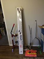 Photo showing the full lot with the corker, boxed rooftop cross bars, fishing pole, net, and rainwear on the floor.