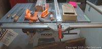 Overview of Ridgid table saw on stand showing top, fence rail and accessories.