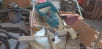Front view of Makita slide compound saw on bench showing overall condition