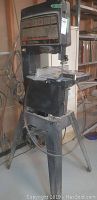 Full view of Craftsman band saw-sander on metal pedestal stand with dust port and power cord