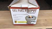 Boxed gel fuel fire pot showing product labeling and brand.