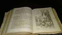 Bible open to detailed biblical text and large engraved illustration of biblical scene.