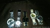 Front view of 5 Kenneth Cole watches in a row, showing different styles and band types.