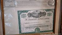 Photo of the stock certificate showing 100 shares issued to Geo. E. Eisenstadt & Co., dated June 23, 1930 with certificate number 140315 and ornate green border design.