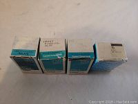 Photo showing four boxes of Potter & Brumfield relays, each box showing the brand, series label, and part numbers or identification. Boxes are blue and white with printed text indicating control components and relays.