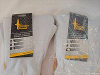 Photo showing one pair of Gander Brand welding gloves with original tags, made of abrasion and heat resistant cowhide leather.