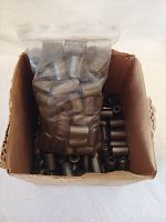 Close-up of the cardboard box with visible metal bearings and a sealed plastic bag full of bearings on top.