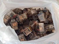 Large bag filled with numerous Porter and Brumfield KR90680 relays.