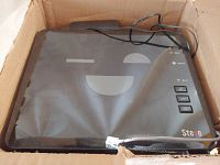 Top view photo of the black Sagemcom Fast 5250 router showing status LEDs and power cord inside a box.