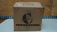 Cardboard box with Caristrap logo printed on it, showing packaging for the straps.