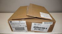 Closed cardboard box showing 3M label with product and barcode information.
