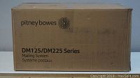 Closed box labeled Pitney Bowes DM125/DM225 Series Mailing System