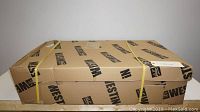 Sealed cardboard box with Westin branding and yellow straps securing the package.