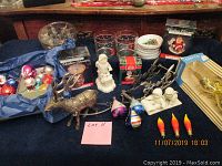 Lot overview showing vintage Christmas bulbs in boxes, reindeer sled decoration, Snow Babies figurines, plates, and flame bulbs.