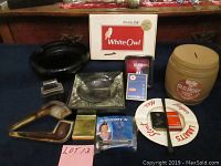 Wide view of all vintage tobacco item collection including pipes, ashtrays, cigarette packs, and tobacco banks