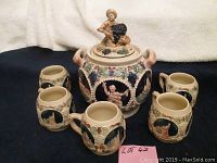Full punch bowl set with one large bowl and six mugs arranged around it
