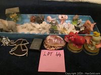 Overview of multiple elephant figurines, brooches, and decorative pieces arranged on a surface including a box display.