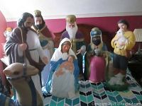 All seven blow mold figures arranged on patterned blanket showing full nativity set
