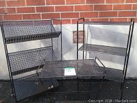 Photo showing all three vintage metal furniture pieces outside against brick wall: glass top table, 3-tier bookcase, and 3-tier shelf