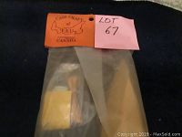 View of sealed original plastic bag containing wooden parts and mast pieces for the 4-masted schooner