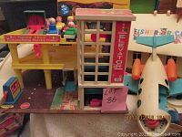 Vintage Fisher-Price parking ramp service center with elevator and 4 Fisher-Price people in cars, blue Fisher-Price toy airplane
