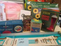 Boxed hummingbird feeder, hummingbird food, garden patio lighting sets, and frost scraper shown on a shelf.