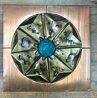Front view of the square copper wall hanging showing the full design and patina.
