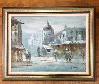 Full view of framed oil painting showing street scene with figures and buildings, signed J. Willson.