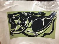 Full view of limited edition numbered and signed print with abstract black and olive green design on cream paper.