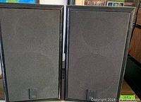 Front view of both JBL 500 speakers side by side, showing black cloth grills and JBL badges.