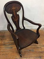 Full view of the mahogany rocking chair showing shape and wood grain