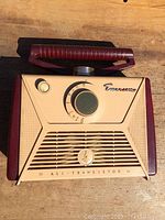 Front view of vintage Emerson transistor radio showing front panel with rotary dial and speaker grill.