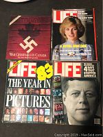 Four vintage magazines laid out flat on a table, showing front covers including a LIFE magazine with Princess Diana, a LIFE Special Edition about war criminals, a LIFE Year in Pictures 83 edition, and a LIFE magazine featuring John F. Kennedy.