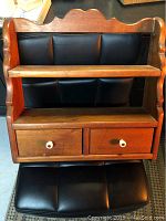 Front view of pine shelf showing two shelves and two drawers with white knobs.