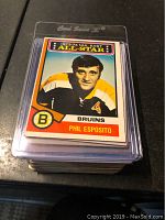 Stack of 1973-74 Phil Esposito OPC hockey cards in a protective plastic case