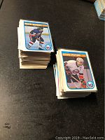 Stack of Mike Bossy and Denis Potvin OPC hockey cards from 1981-82 showing front card images and number of cards.
