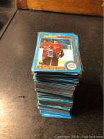 Stack of 1979-1980 Topps hockey cards on a black surface.