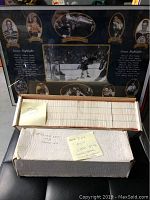 Two white boxes filled with hockey cards from 1989-1990 and a large framed Bobby Orr career highlights photo with multiple images and text.