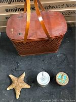 Closed view of vintage wicker picnic basket with wooden lids and handles