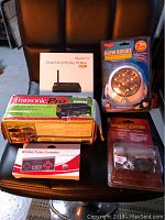 Photo showing all items in the lot with original boxes and packaging: MyGica streaming box, electronic pest control, bike light, wireless NES controller, outdoor LED light.