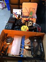 Photo showing entire lot contents including Shark Pack waterproof case, Sony Walkman, Bushnell mini binoculars and other electronics.