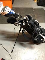 Left-handed TaylorMade stand golf bag fully loaded with clubs deployed on stand