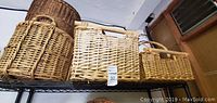 Four wicker baskets on wire shelving showing different shapes, sizes, and colors.
